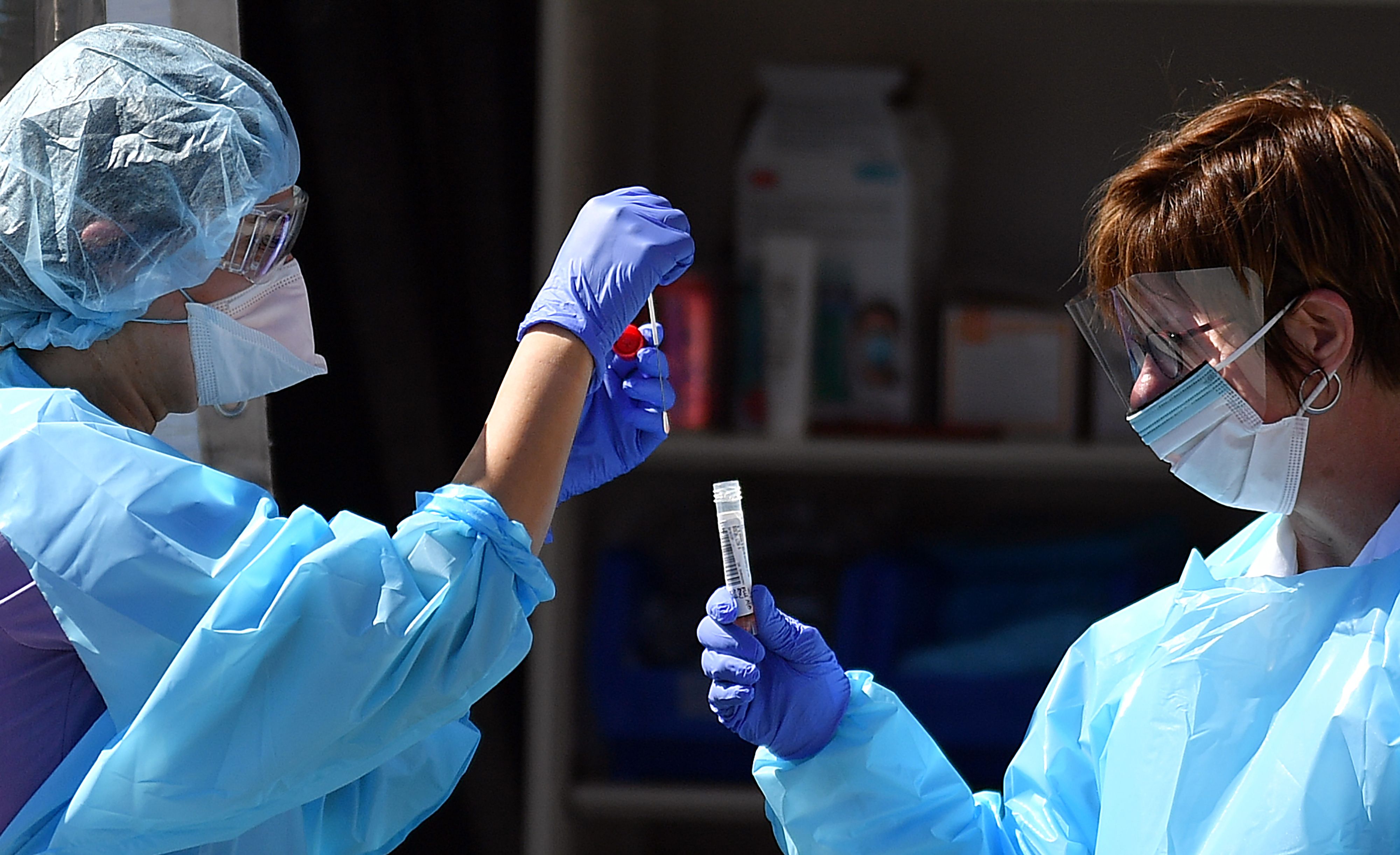 Medical workers at Kaiser Permanente French Campus test a patient for the novel coronavirus, COVID-19, at a drive-thru testing facility in San Francisco, California on March 12, 2020. - Between 70 to 150 million people in the United States could eventually be infected with the novel coronavirus, according to a projection shared with Congress, a lawmaker said March 12, 2020. (Photo by Josh Edelson / AFP) (Photo by JOSH EDELSON/AFP via Getty Images)